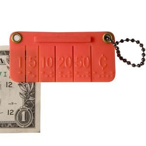 A one dollar bill being labeled with the braille money labeling keychain. 