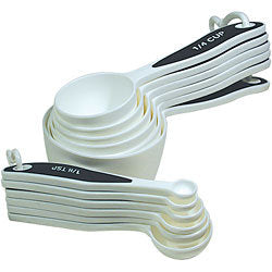 White measuring cups and spoons with black handles and large white print.
