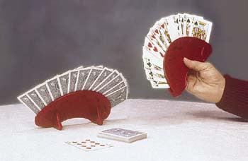 Hand holding a hand of cards in the round playing card holder. Another holder is shown standing up on it's own on the table. 